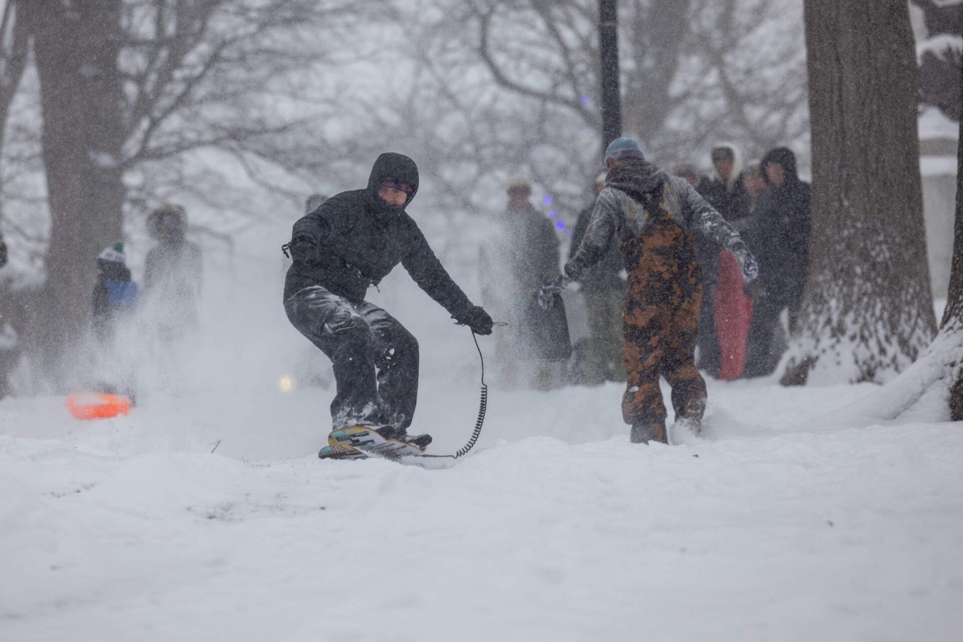 A person snowboards down hill on Boston Common Jan. 25, 2026. (Scott Eisen/Getty Images)