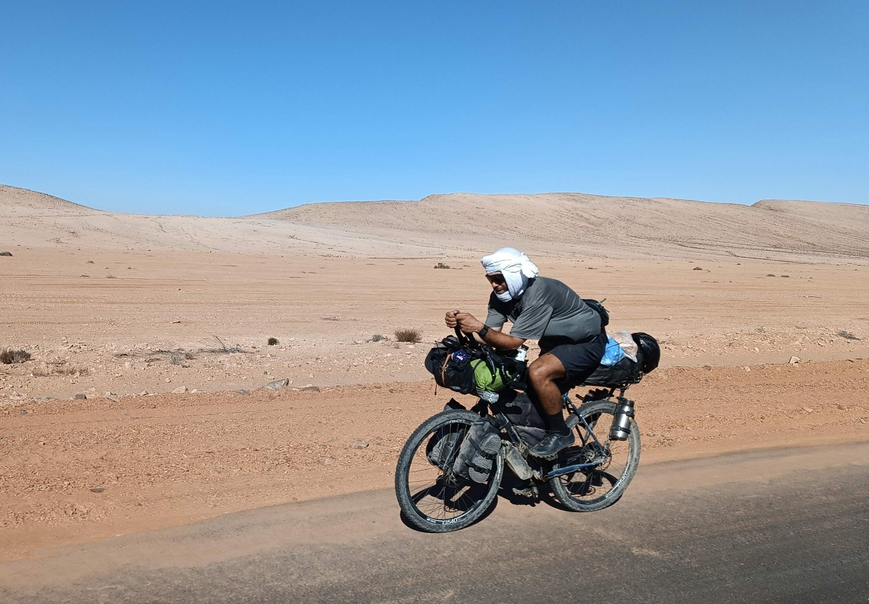 Samer Abouhamad bikes through a desert. (Courtesy of Samer Abouhamad)