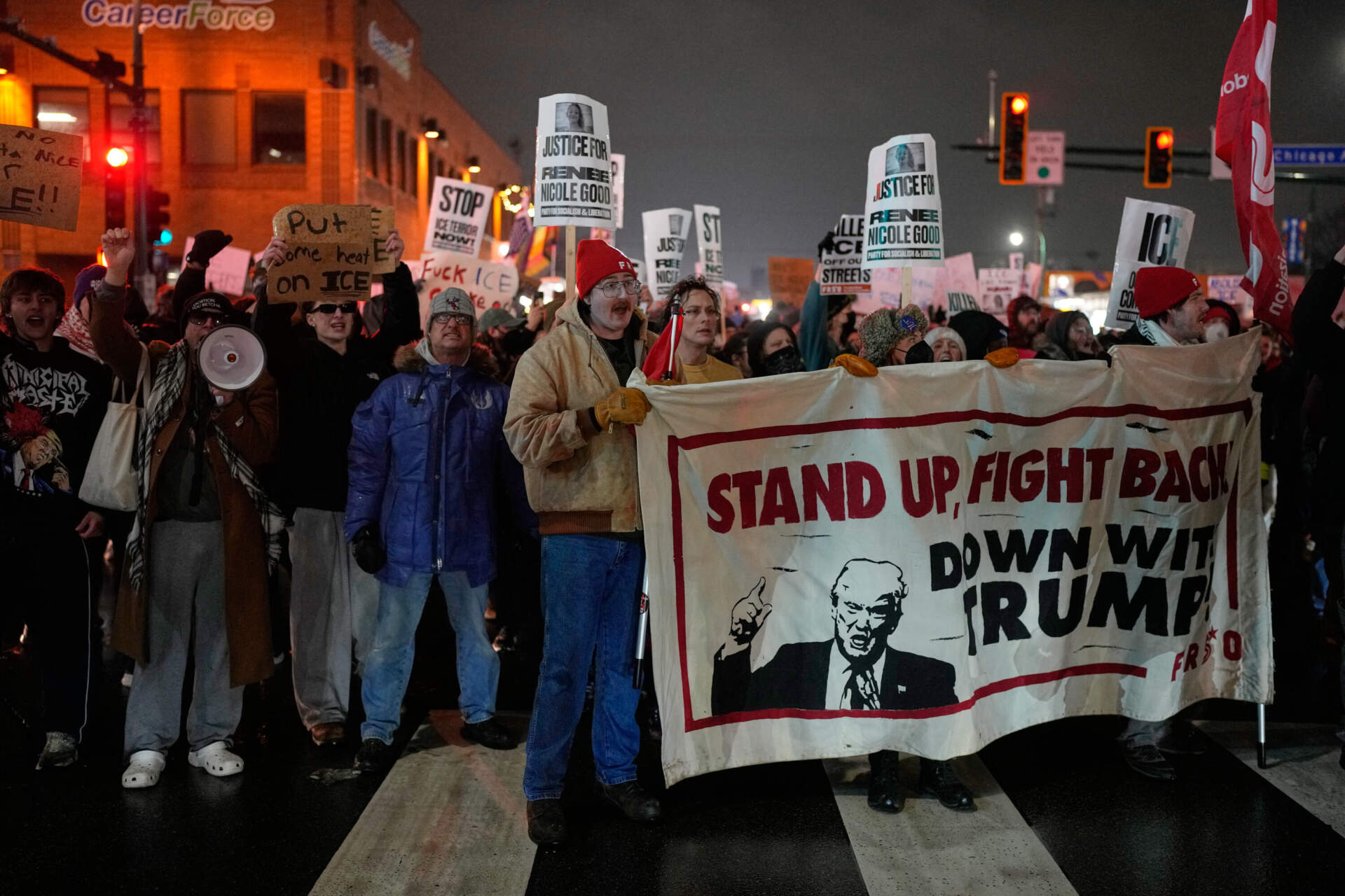 Protesters chant and march during a rally for Renee Good in Minneapolis on Thursday. (John Locher/AP)