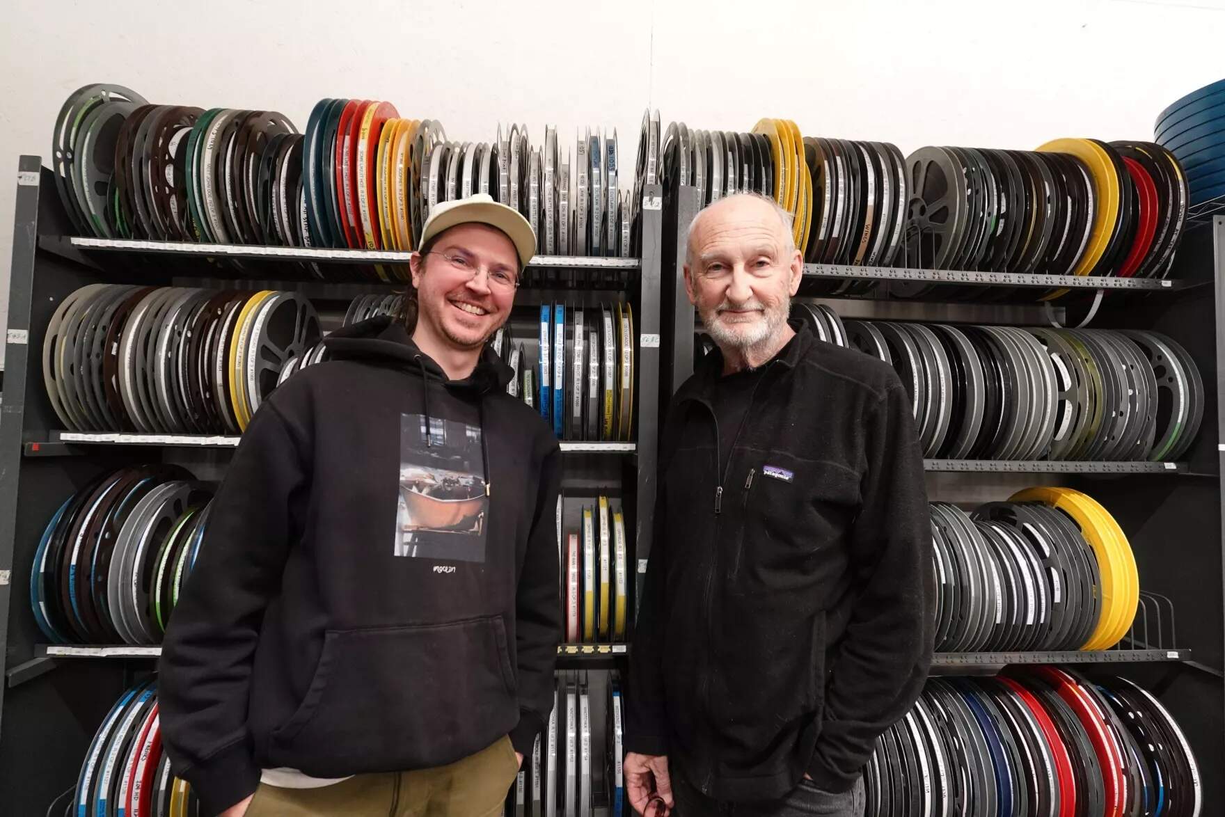 Skylar Kelly, left, and Andy Graham, right, are co-founders of the non-profit Kinonik, which shows older movies on film from its small space in Portland. (Tulley Hescock/Maine Public)