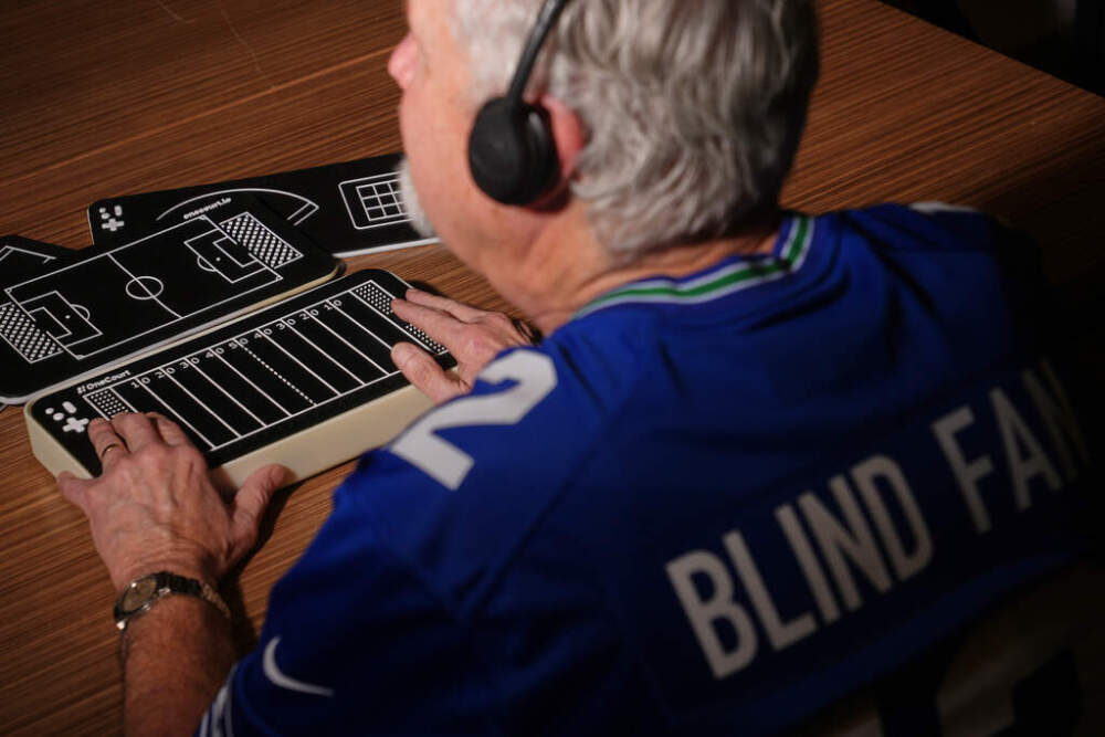 Clark Roberts, a blind Seattle Seahawks fan, uses a OneCourt tablet, a tactile device that translates gameplay into trackable vibrations along with real-time audio, at the T-Mobile Innovation Hub Tuesday, Jan. 27, 2026, in Bellevue, Wash. (Lindsey Wasson/AP)