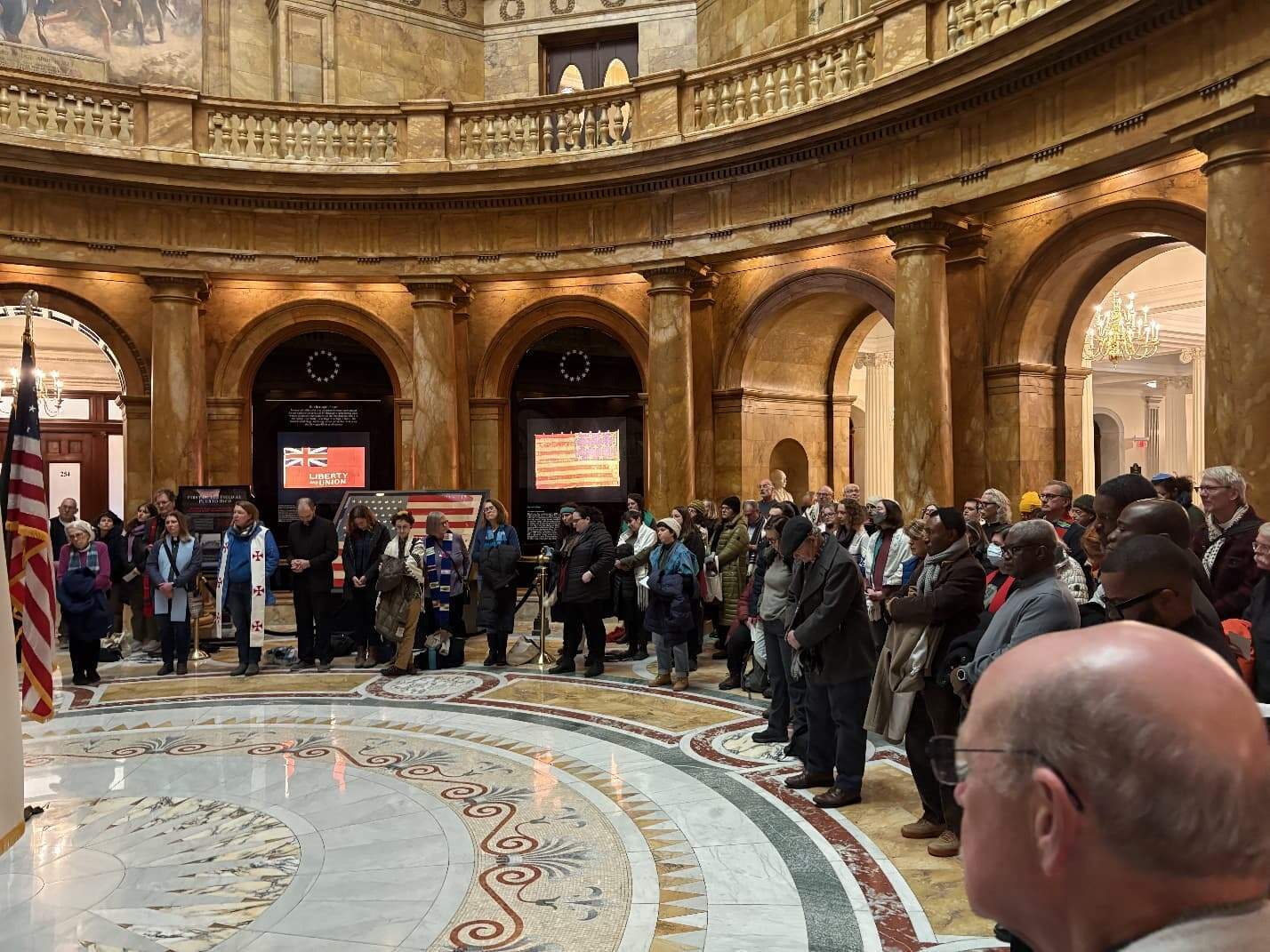 Faith leaders gather at the State House on Jan. 23 to urge Gov. Maura Healy to take executive action to protect Massachusetts residents from Immigration and Customs Enforcement operations. (Anna Rubenstein/WBUR)