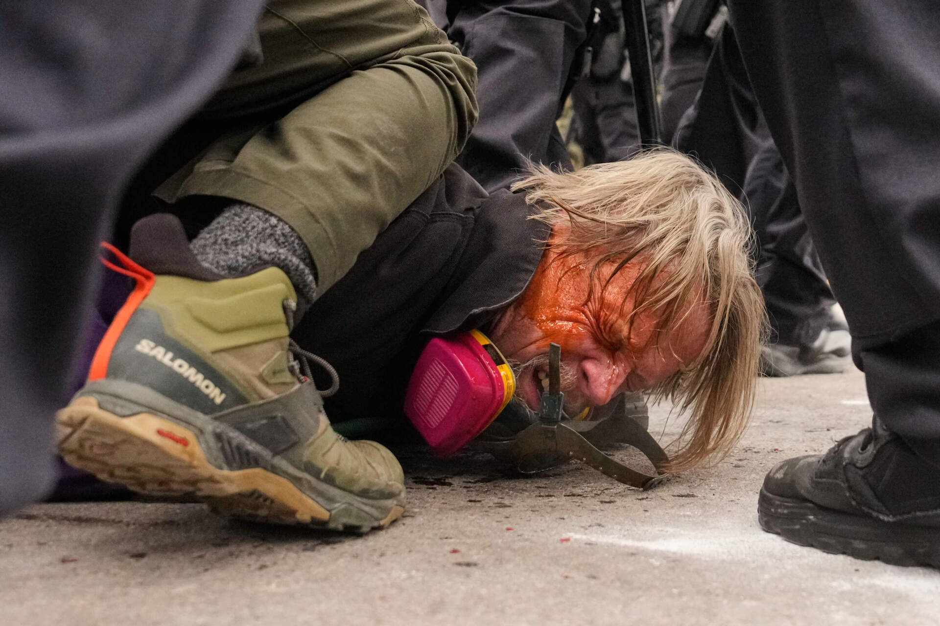 A man is pushed to the ground as federal immigration officers confront protesters outside Bishop Henry Whipple Federal Building on Jan. 15 in Minneapolis. (John Locher/AP)