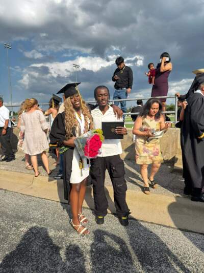 Paulete Mbuangi, left, with her brother Emanuel Landila, at Mbuangi's high school graduation in 2024. Mbuangi, now in college, describes Landila as a devoted older brother to his six younger siblings. (Photo courtesy Paulete Mbuangi)