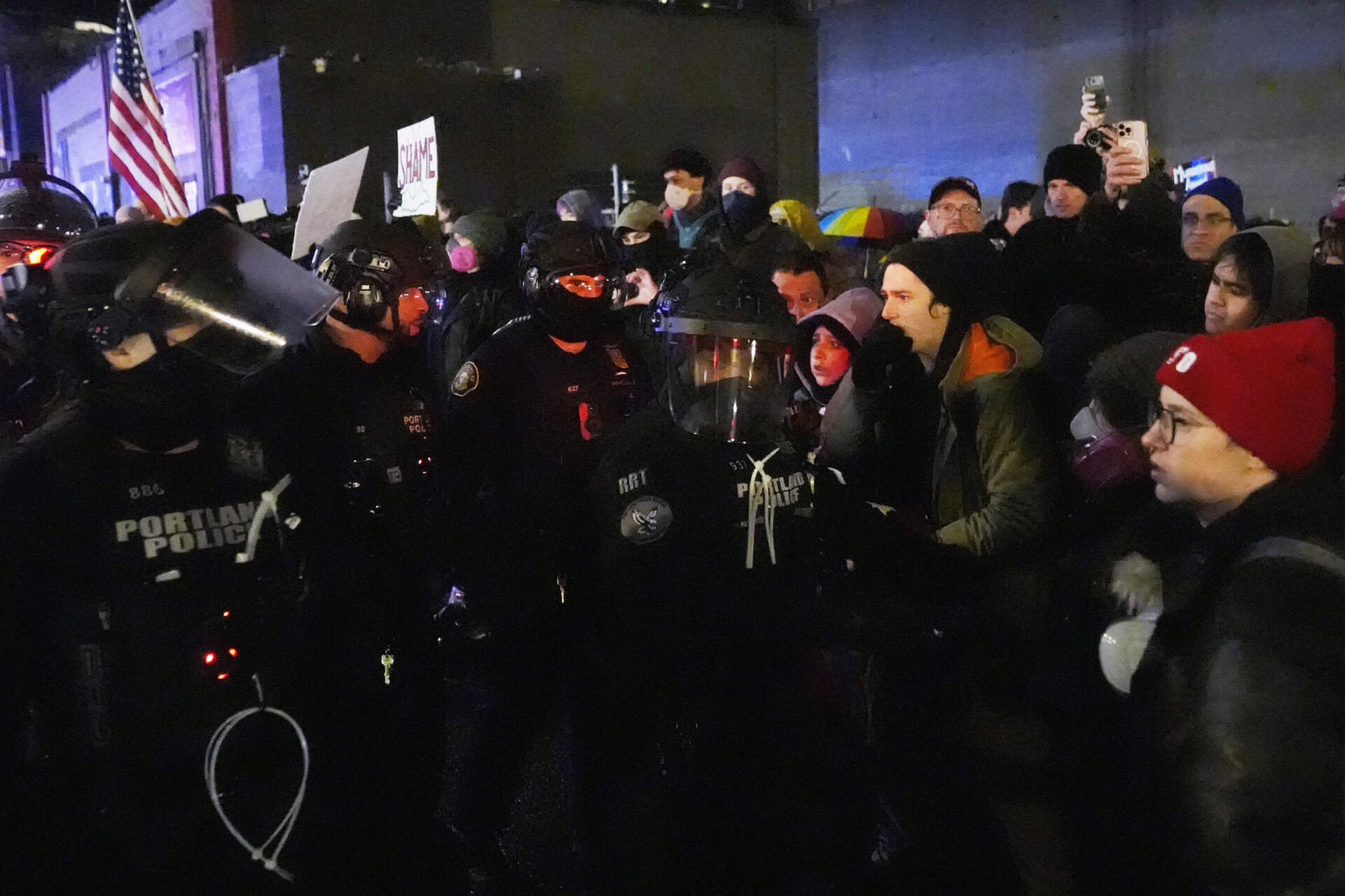 Protesters stand off against law enforcement outside the U.S. Immigration and Customs Enforcement facility in Portland, Oregon, Thursday. (Jenny Kane/AP)