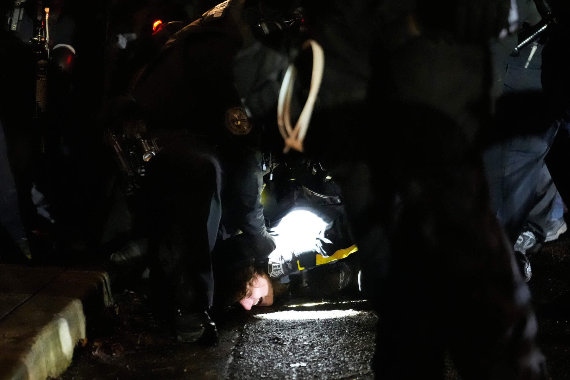 Law enforcement detain a protester in Portland, Oregon, on Thursday. (Jenny Kane/AP)