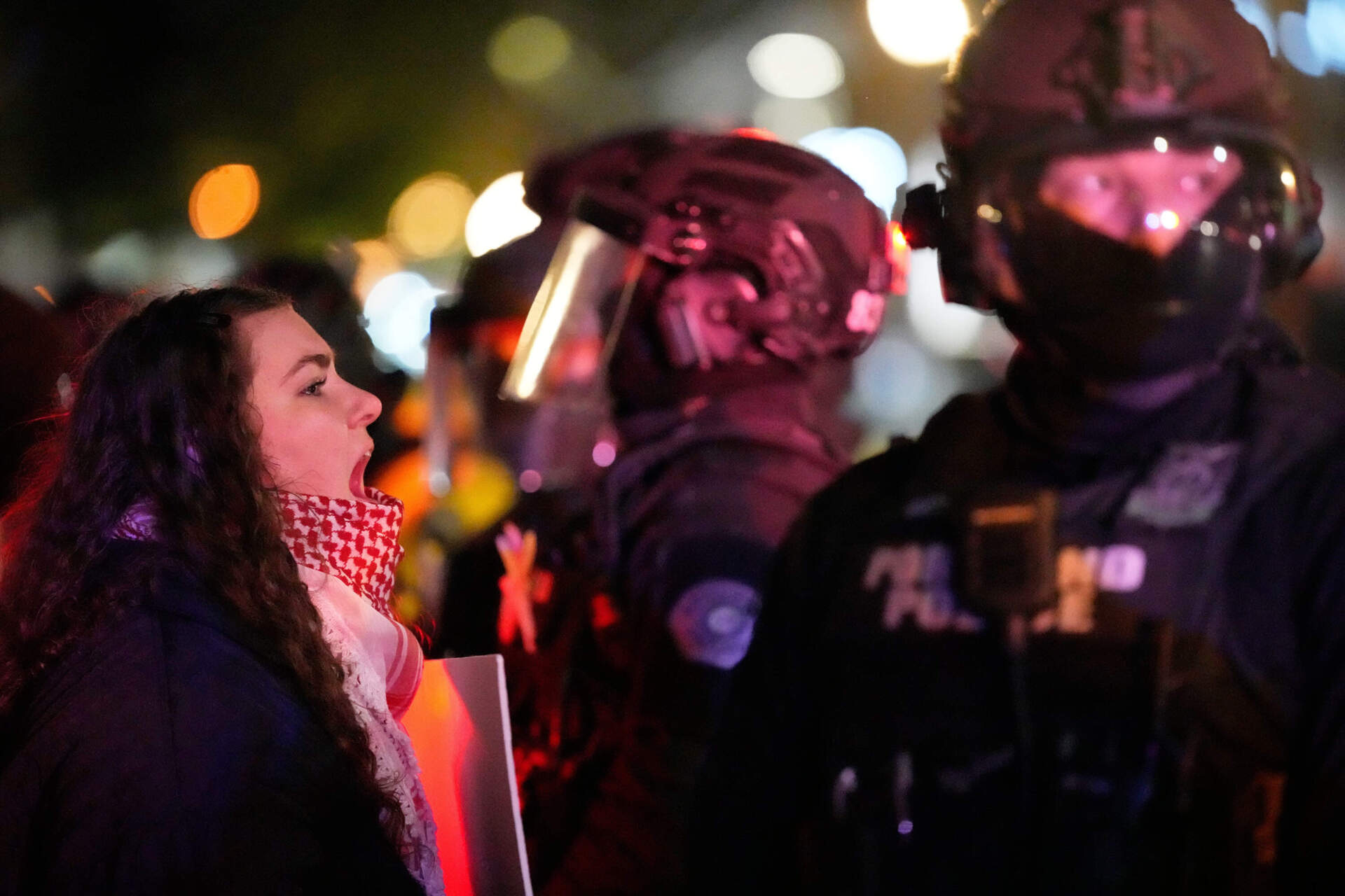 A protester yells at a Portland police officer outside the U.S. Immigration and Customs Enforcement facility on Thursday, Jan. 8, in Portland, Oregon. (Jenny Kane/AP)