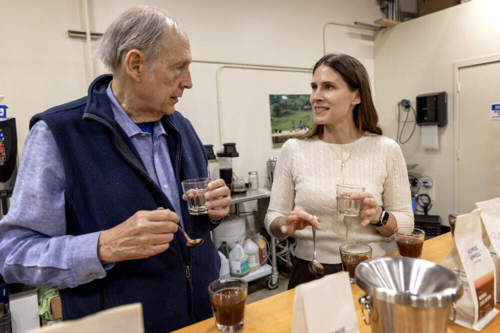 George Howell and his daughter Jennifer Howell discuss coffee samples at a cupping session at the George Howell Coffee roastery in Acton, Mass. (Robin Lubbock/WBUR)