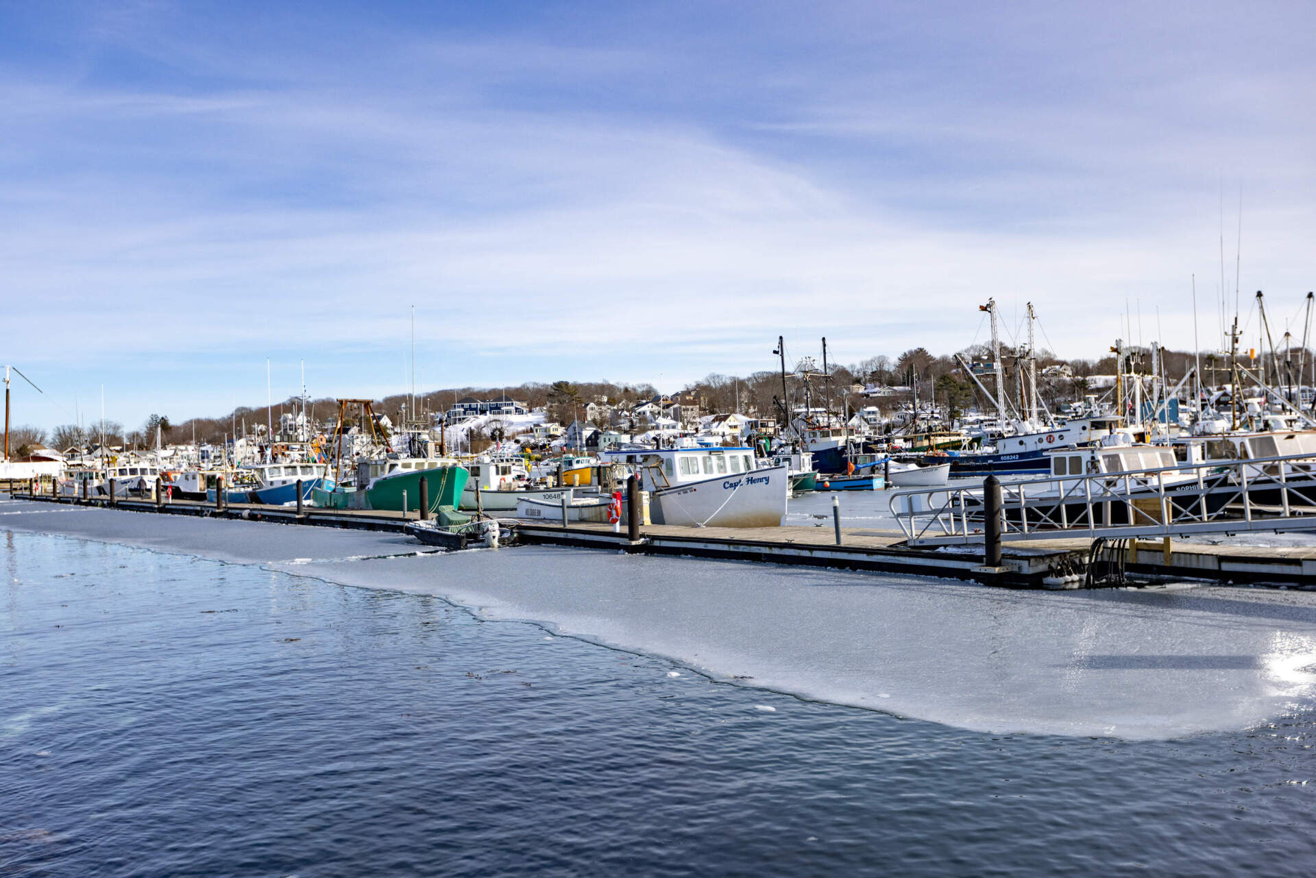 Fishing boats docked in the icy waters at the State Fish Pier in Gloucester. (Jesse Costa/WBUR)