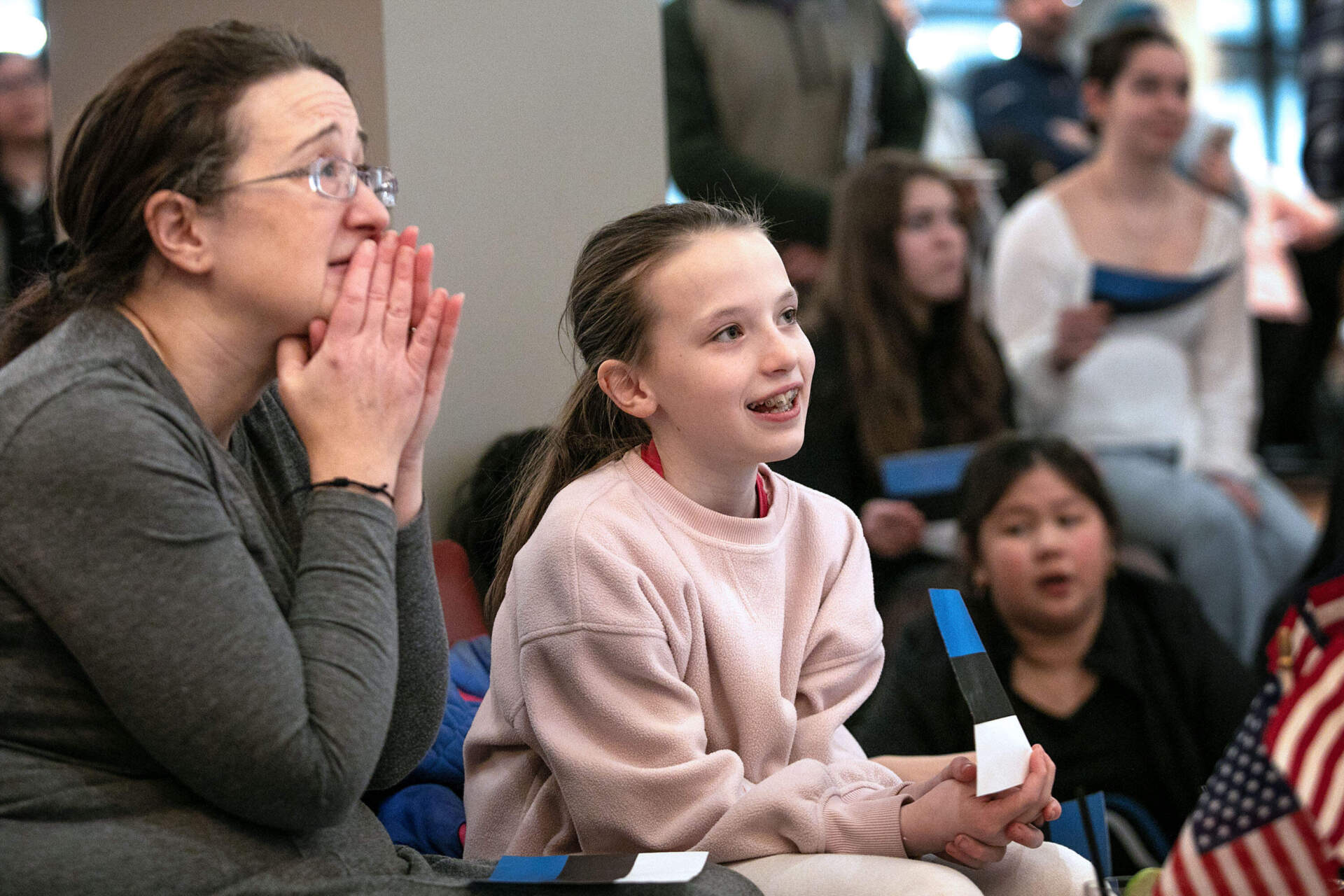 At the Skating Club of Boston, skater Aimee and her mom Beth Lindberg watch Maxim Naumov's performance at Milan Olympics. (Robin Lubbock/WBUR)