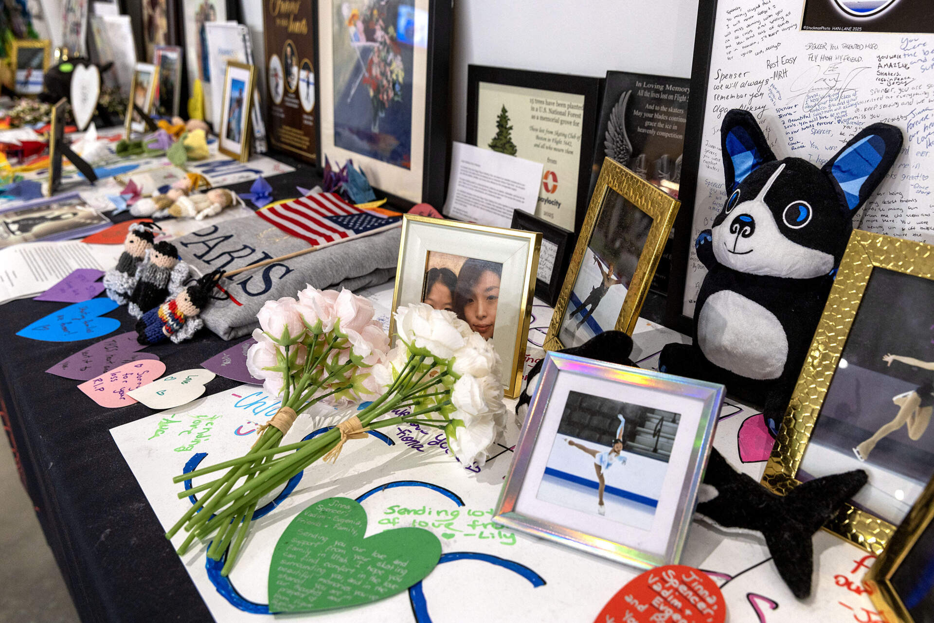 A memorial table for the members of the Skating Club of Boston who died in a January 2025 plane crash in Washington, D.C. (Robin Lubbock/WBUR)