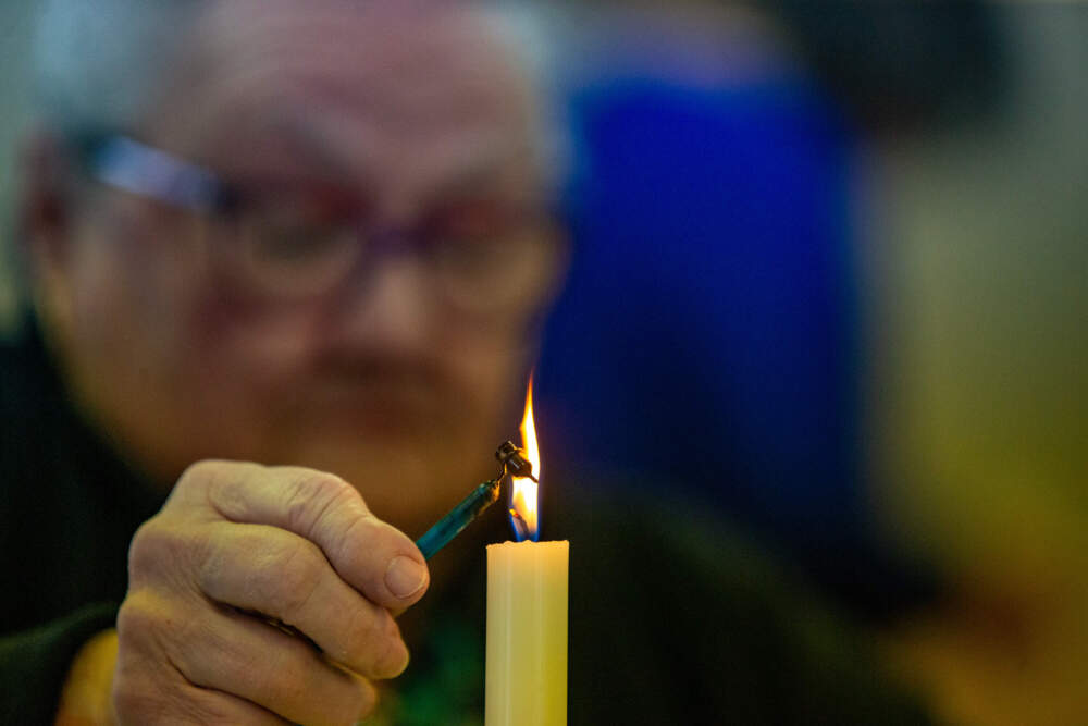 Olya Baryski heats up the wax in the Kistka to design the egg she is working on. (Jesse Costa/WBUR)