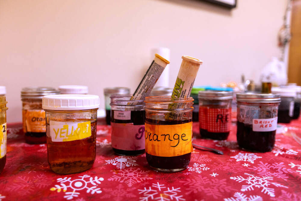 A table loaded with dyes used to color the eggs. (Jesse Costa/WBUR)