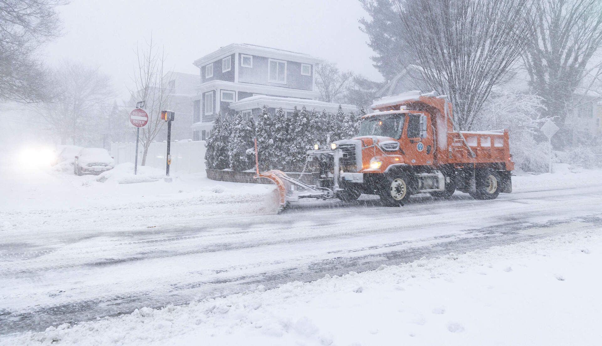 A snowplow makes its way along Concord Avenue in Cambridge Monday morning. (Robin Lubbock/WBUR)