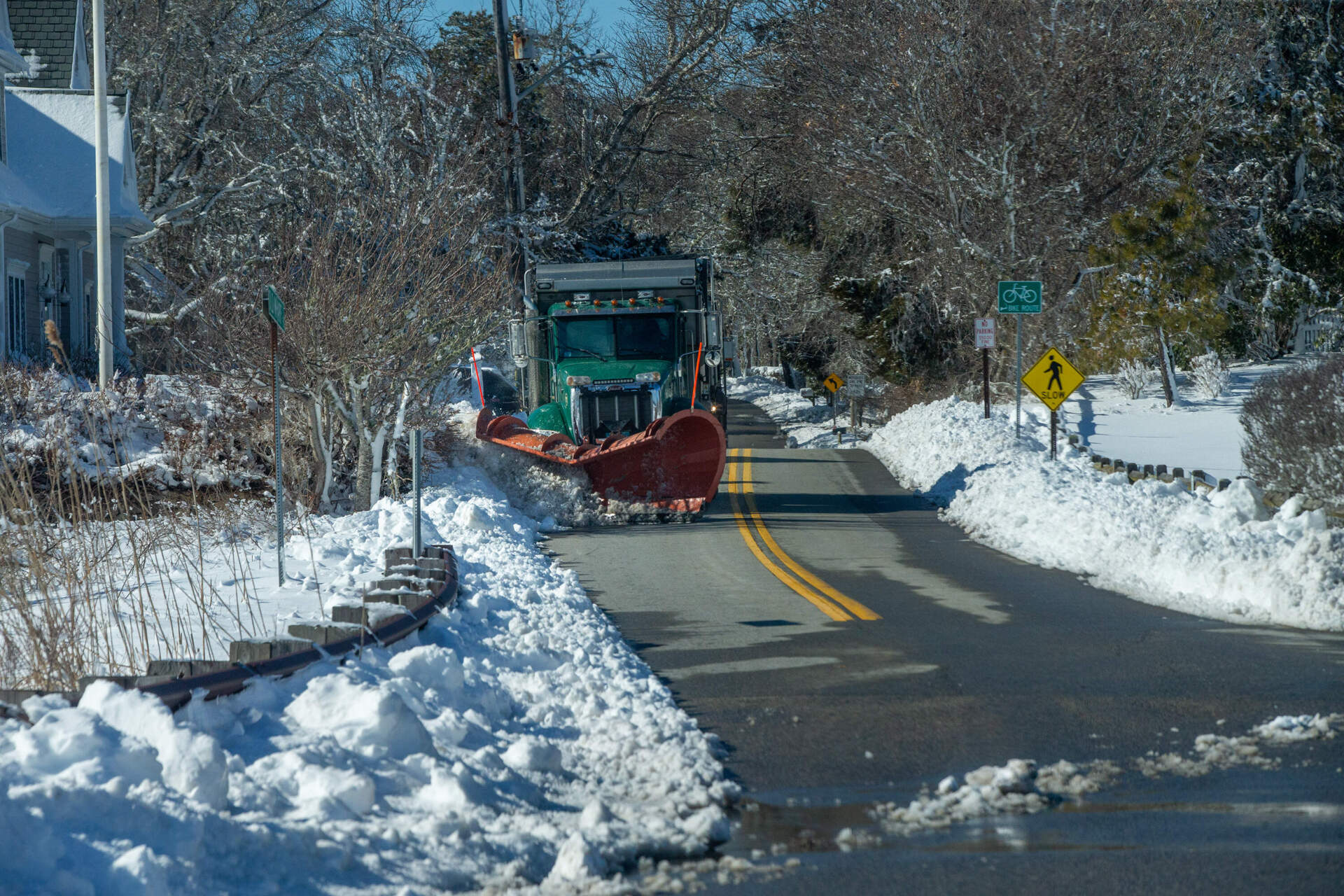 A plow does additional snow clean up at Red River Beach in Harwich. (Jesse Costa/WBUR)