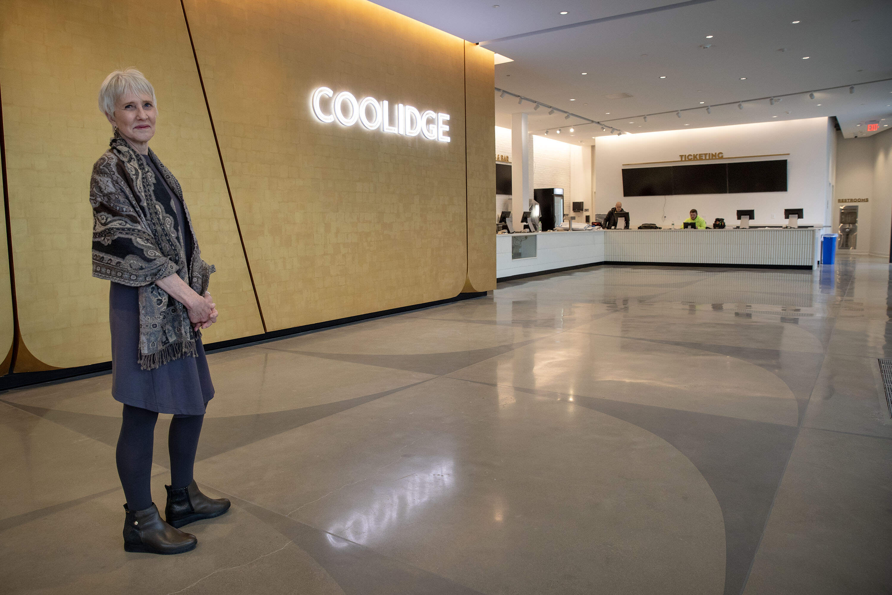 Coolidge Corner Theatre executive director and CEO Katherine Tallman standing in the new foyer of the cinema in 2024. (Robin Lubbock/WBUR)