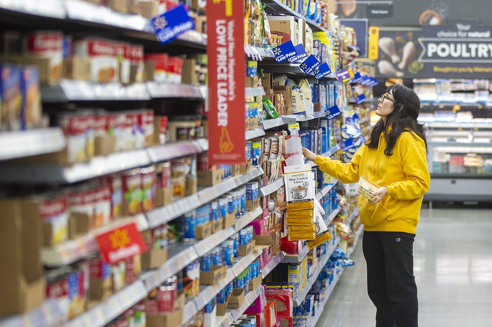 A customer peruses an aisle at the Walmart supercenter in Salem, New Hampshire in 2019. (Jesse Costa/WBUR File)