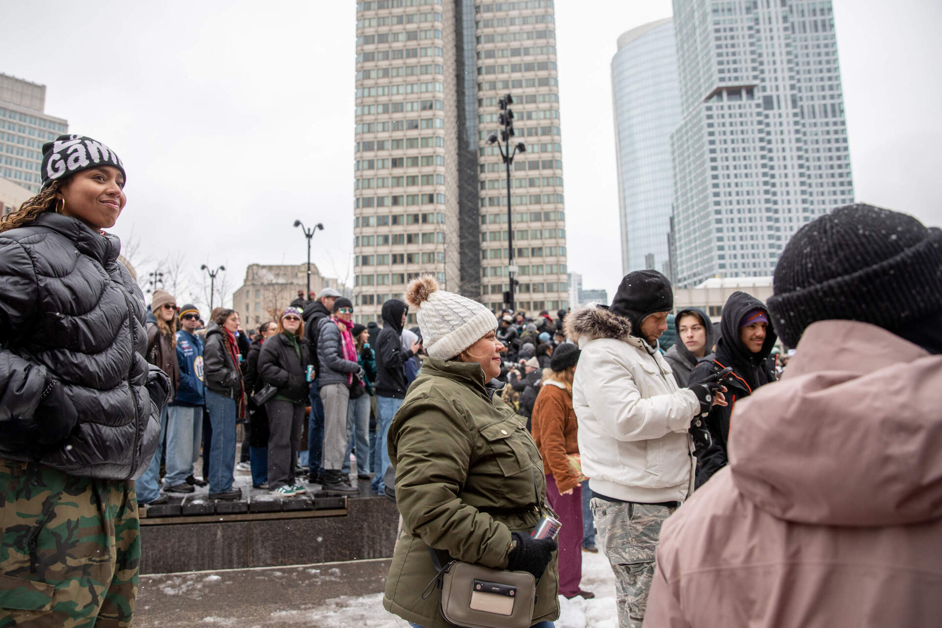 Iris Morales of East Boston (center) watches the competition in City Hall Plaza. (Artemisia Luk/WBUR)