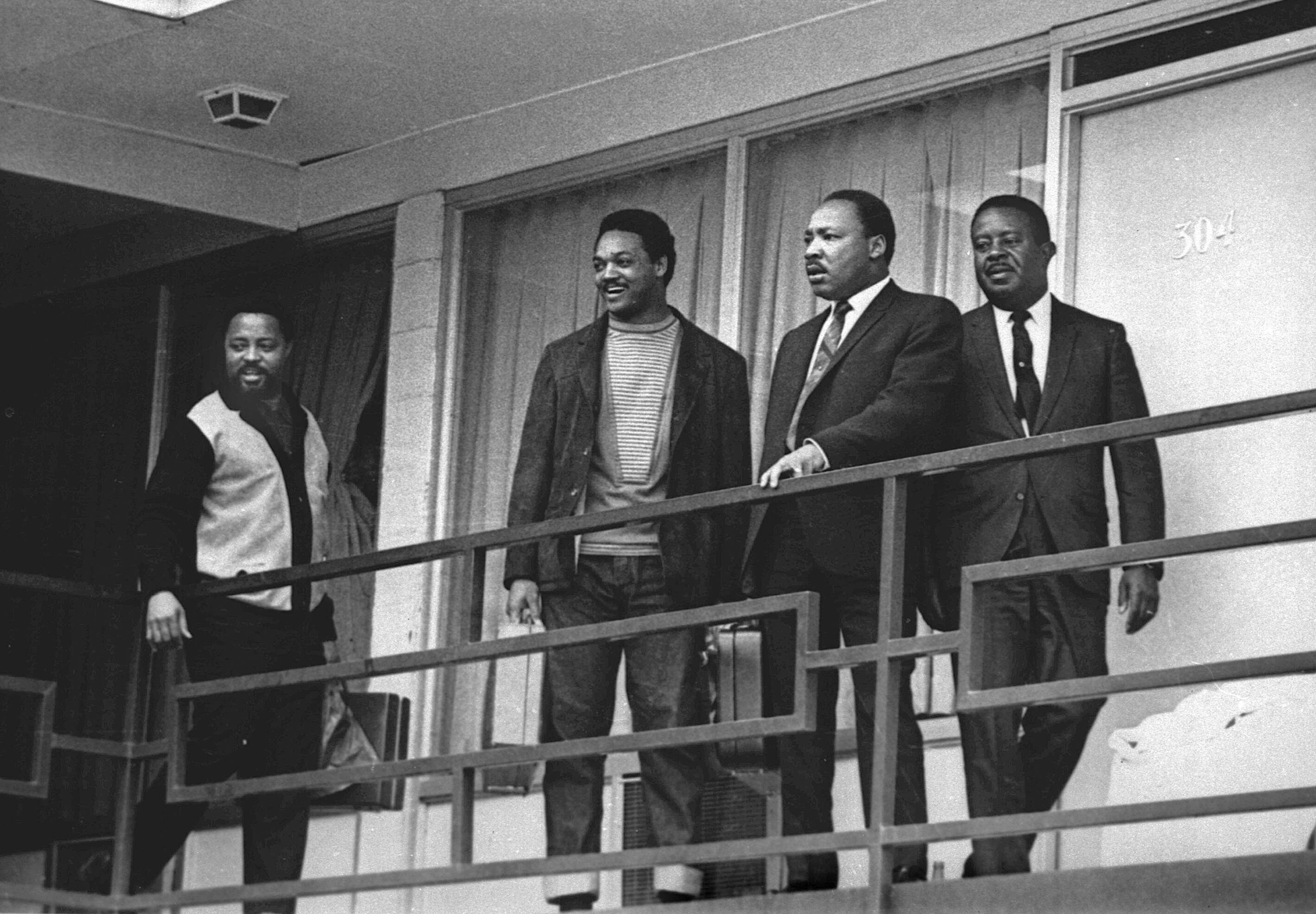Rev. Martin Luther King Jr., second from right, stands with Hosea Williams, left, Jesse Jackson, second from left, and Ralph Abernathy, right, on the balcony of the Lorraine Motel in Memphis, Tenn., a day before he was assassinated at approximately the same place, April 3, 1968. (Charles Kelly/AP)