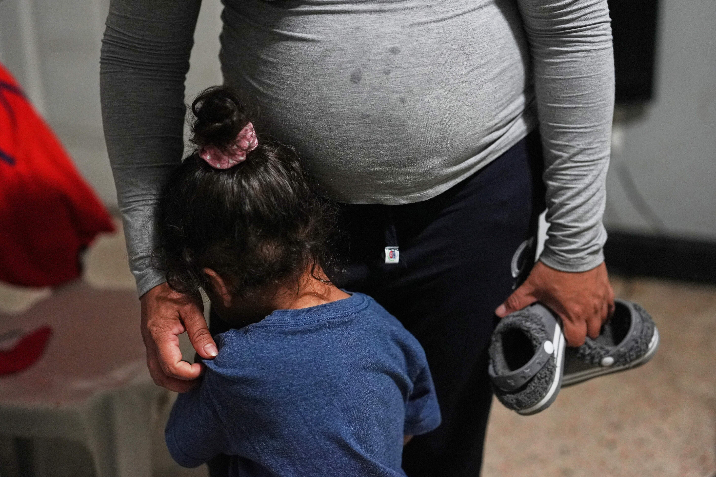 Pregnant asylum-seeker comforts her 2-year-old son who was not feeling well, inside the Miami-area motel room where she and her two children are living after her husband was deported to Nicaragua, Thursday, Nov. 13, 2025. (Rebecca Blackwell/AP)