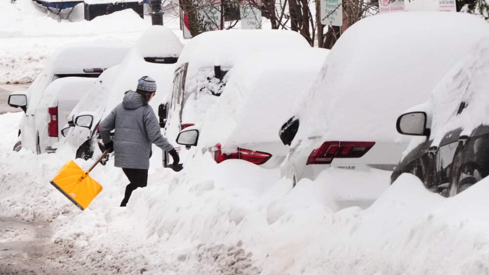 A woman walks with a shovel after digging out a path on Beacon Hill following a winter storm that dump more than a foot of snow across the region, Monday, Jan. 26, 2026, in Boston. (Charles Krupa/AP)