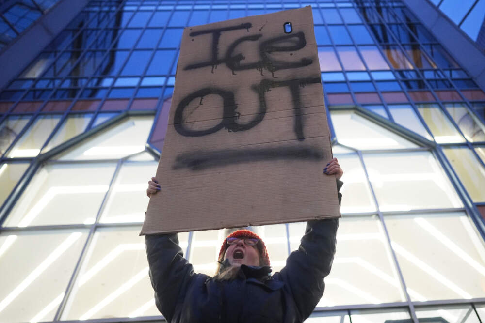 A demonstrator holds a sign reading "ICE OUT" during a protest outside the office of Sen. Amy Klobuchar, D-Minn., on Monday, Jan. 26, 2026, in Minneapolis. (Adam Gray/AP)