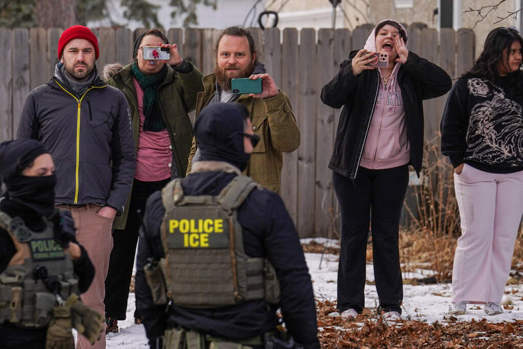In this file photo, observers film while federal agents conduct immigration enforcement operations in Minneapolis on Thursday, Feb. 5. (Ryan Murphy/ AP)