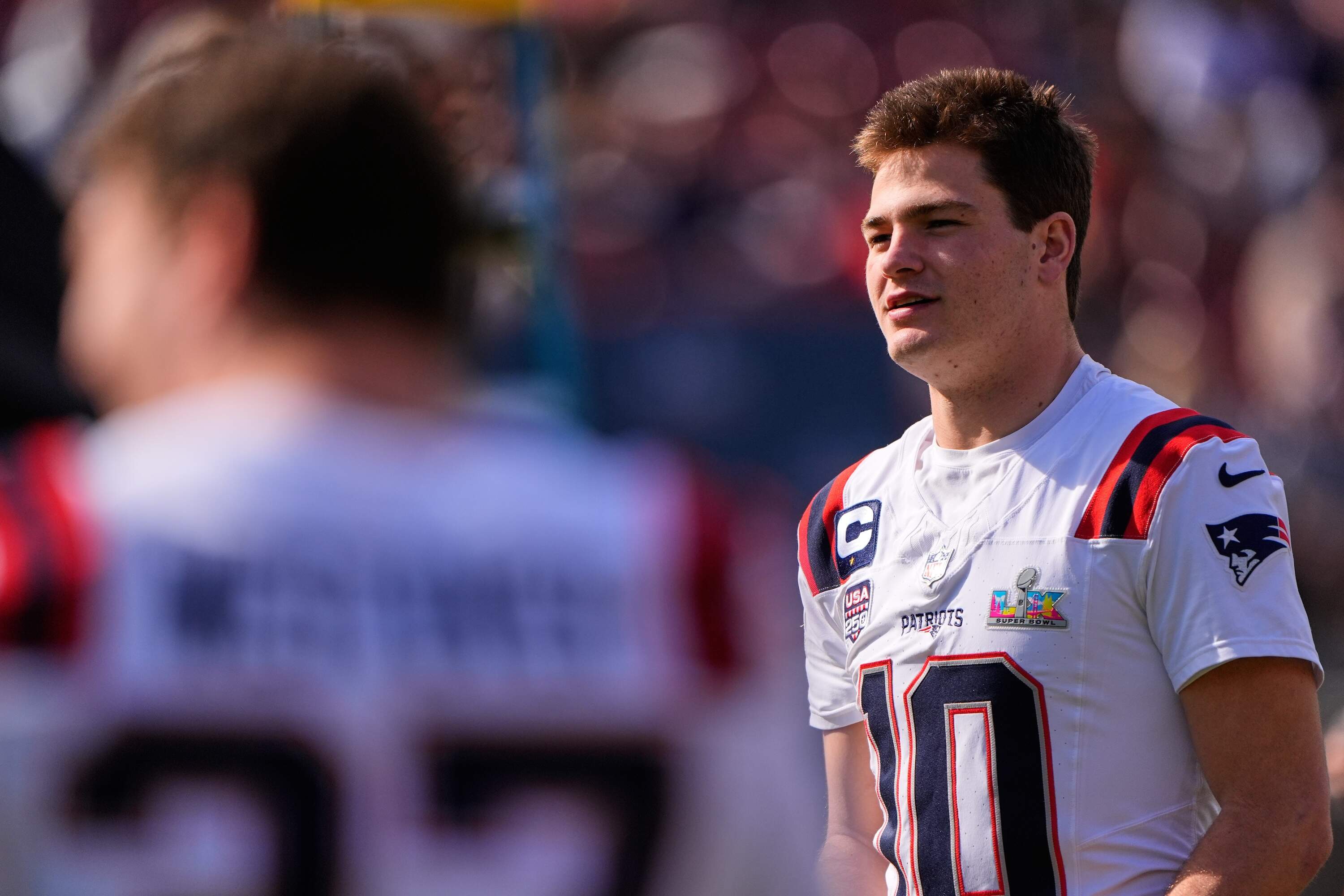 New England Patriots quarterback Drake Maye waits to be in a group photo at their practice venue for the Super Bowl 60 NFL football game against the Seattle Seahawks, Saturday, Feb. 7, 2026, in Stanford, Calif. (Charlie Riedel/AP)