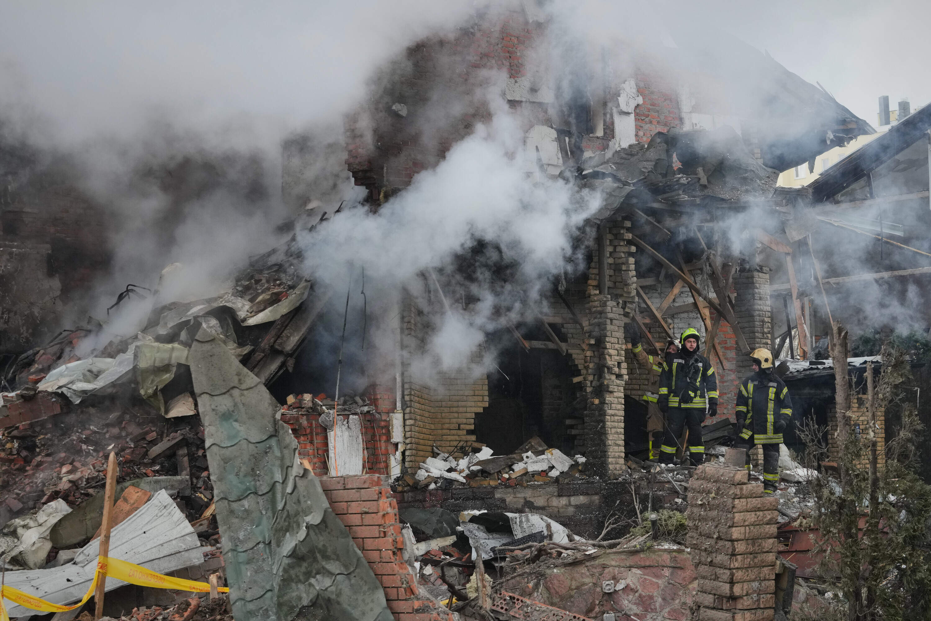 Firefighters put out a fire after a drone hit a residential building during a Russian air attack in Kyiv, Ukraine, Sunday, Feb. 22, 2026. (Sergei Grits/AP)