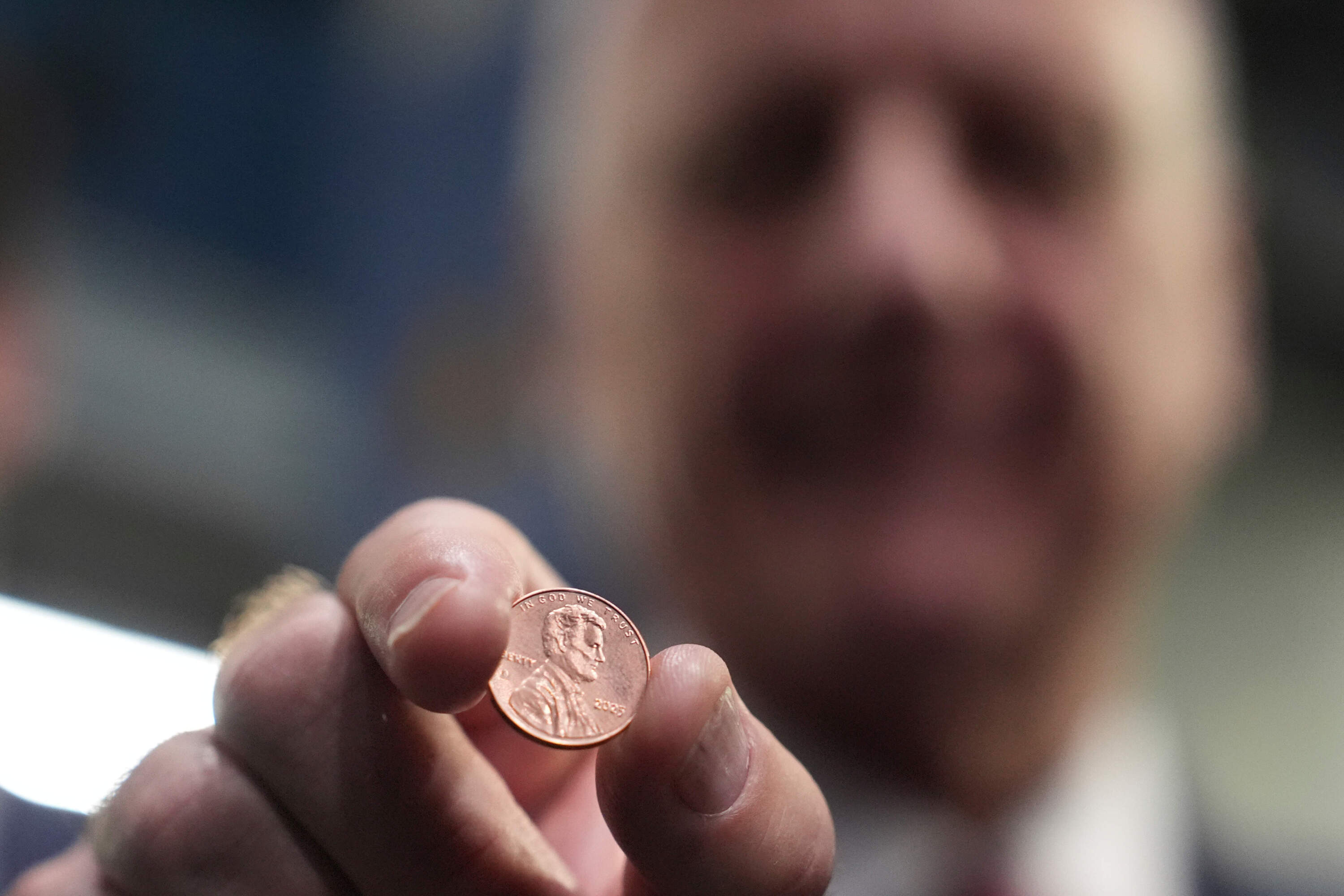 U.S. Treasurer Brandon Beach holds one of the last pennies pressed at the U.S. Mint in Philadelphia on Nov. 12, 2025.