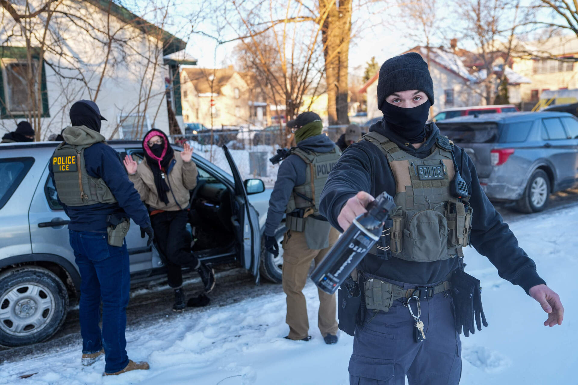 Activists are approached by federal agents for following agent vehicles, on Tuesday, Feb. 3, in Minneapolis. (Ryan Murphy/AP)