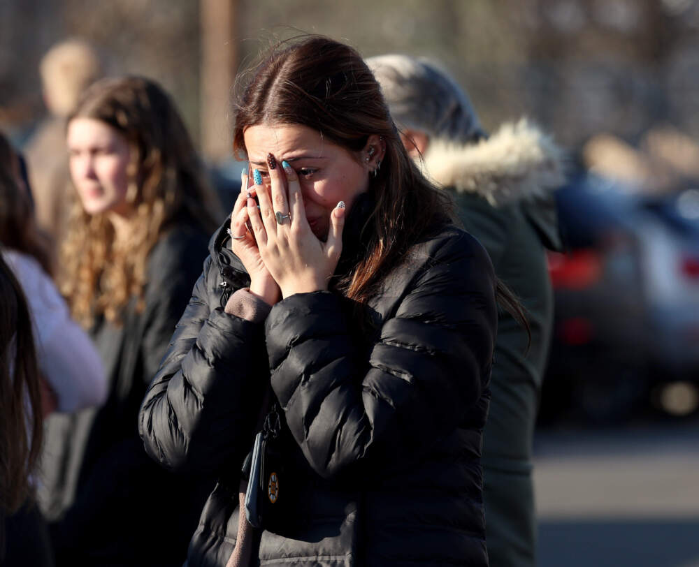 A woman reacts near the Lynch Arena in Pawtucket, R.I., after a shooting at the ice rink on Feb. 16. (Mark Stockwell/AP)