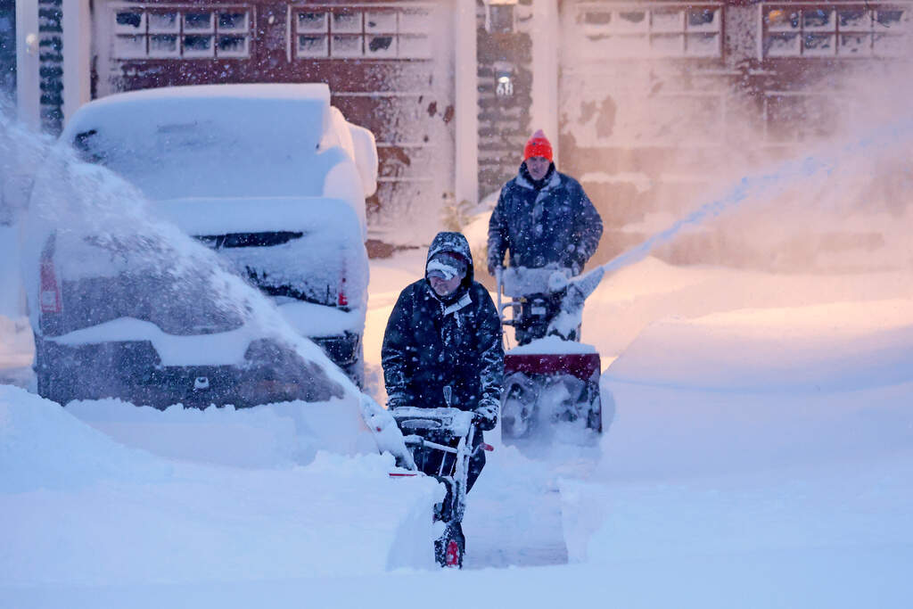 Neighbors team up to clear a driveway, Monday, Feb. 23, 2026, in North Attleborough, Mass. (Mark Stockwell/AP)