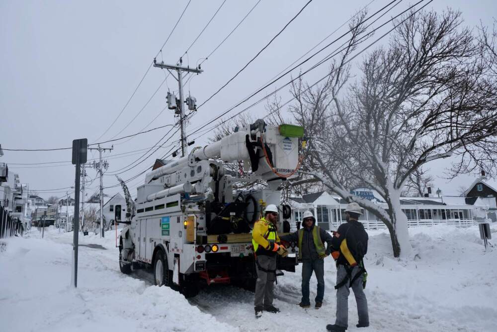 Utility workers repair a power line in Plymouth. (Patrick Madden/WBUR)