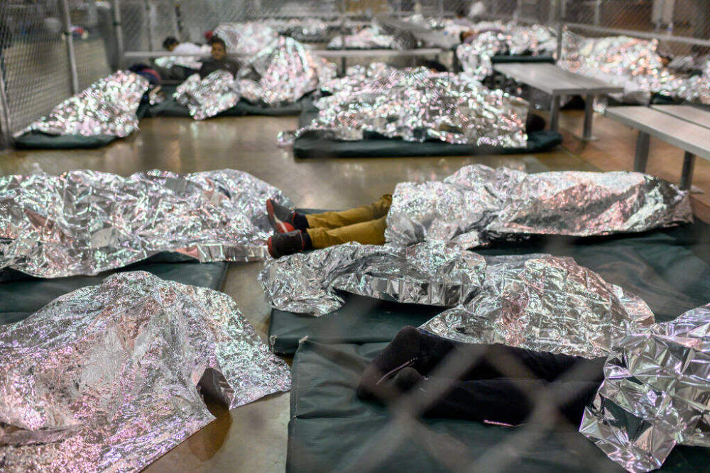 Male minors rest under mylar blankets in the US Border Patrol Central Processing Center in McAllen, Texas on August 12, 2019. (Carolyn Van Houten/The Washington Post via Getty Images)
