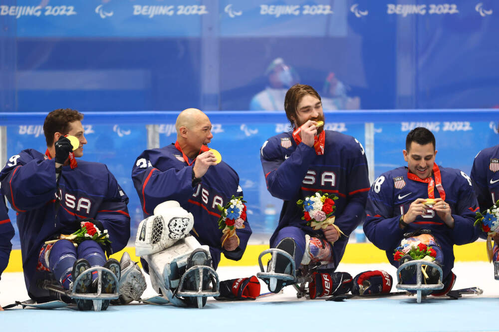 From left to right, Griffin Lamarre #29, Jen Lee #32, David Eustace #37 and Kevin McKee #88 of Team USA celebrate during the sled hockey medal ceremony after the gold medal game in the Beijing 2022 Winter Paralympics, March 13, 2022 in Beijing, China. (Michael Steele/Getty Images)