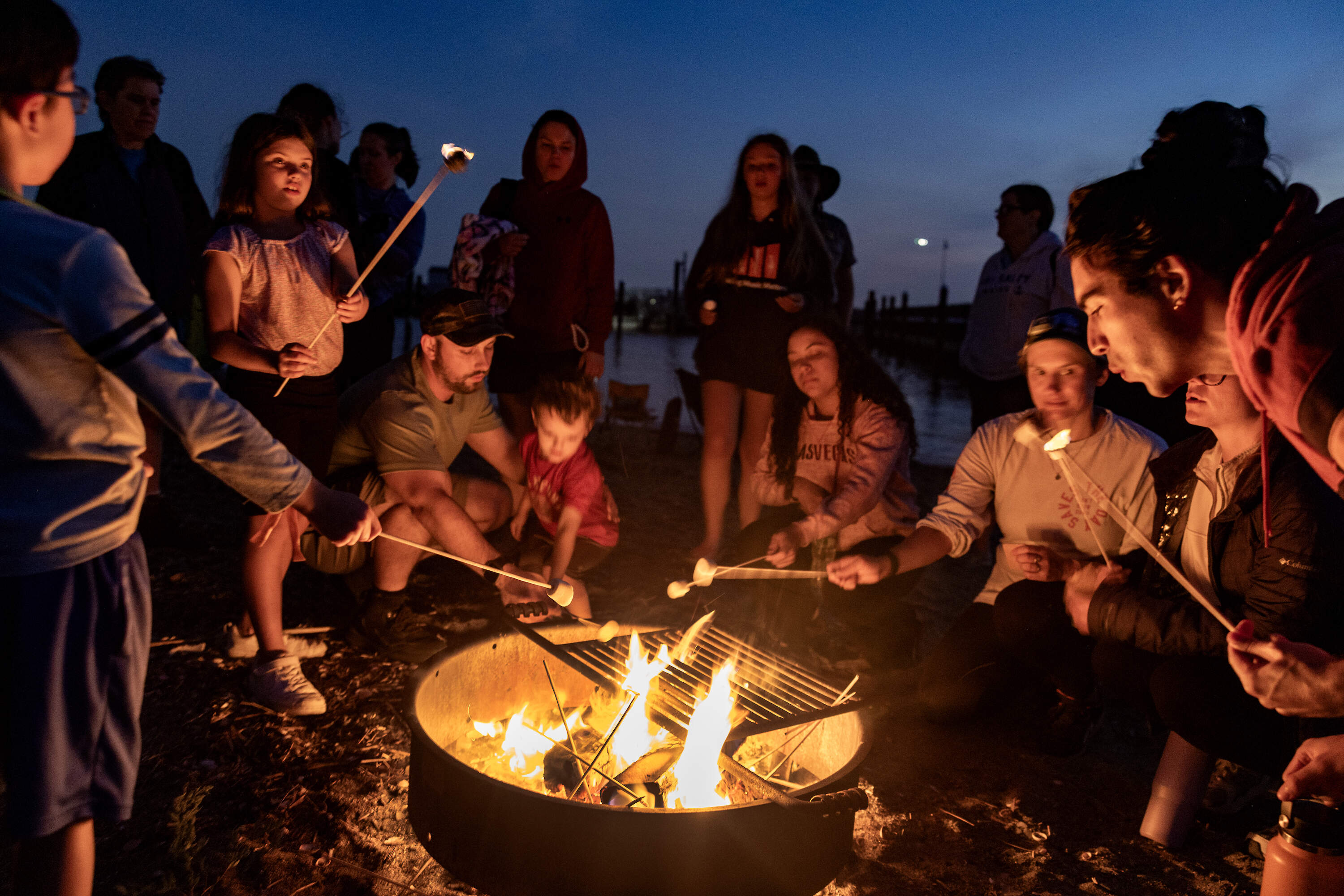 Campers toast s'mores on the beach at night on Spectacle Island last August. (Stan Grossfeld/The Boston Globe via Getty Images)