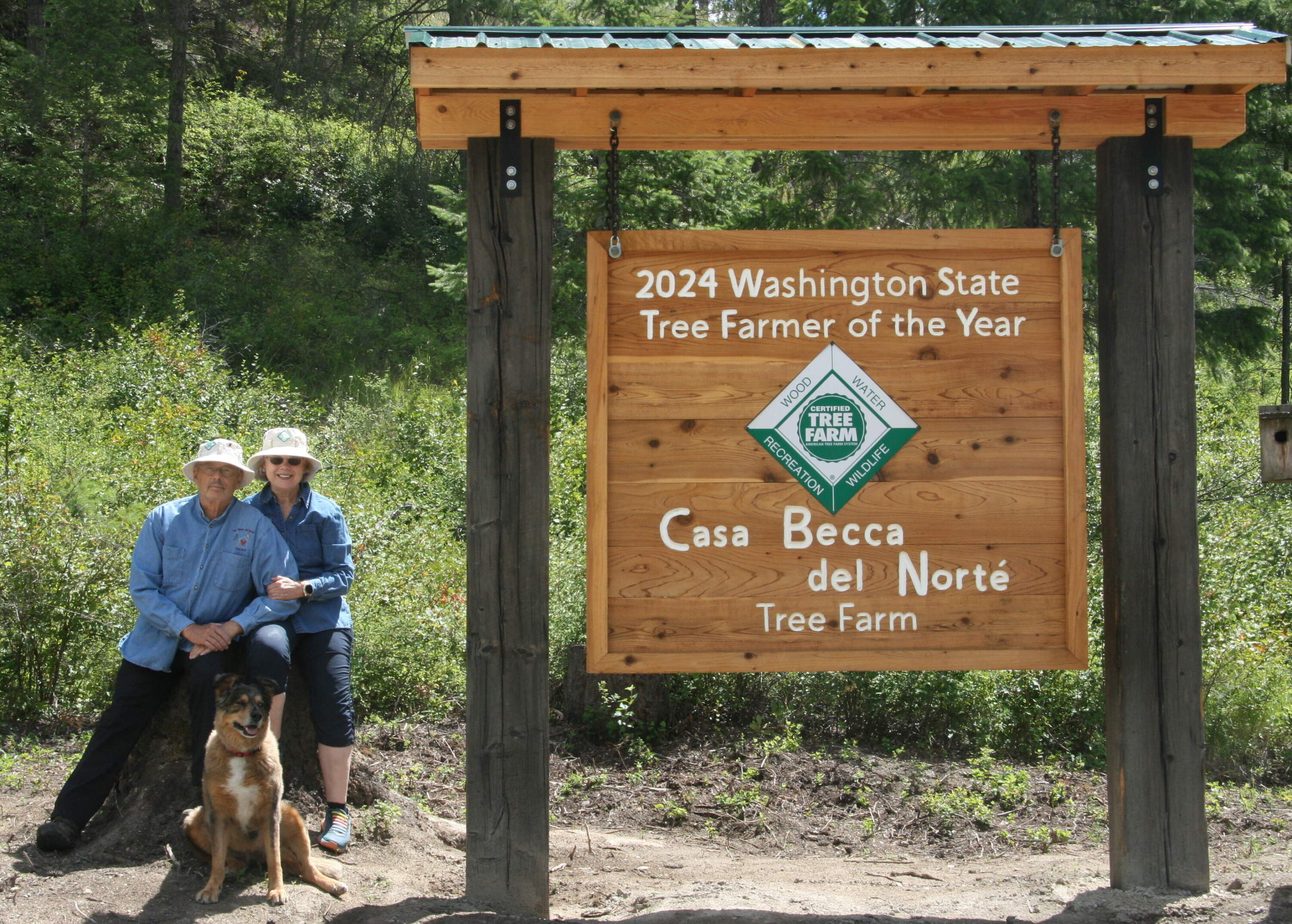The couple with the sign to their farm. (Courtesy of Lynn and Becky Miner)