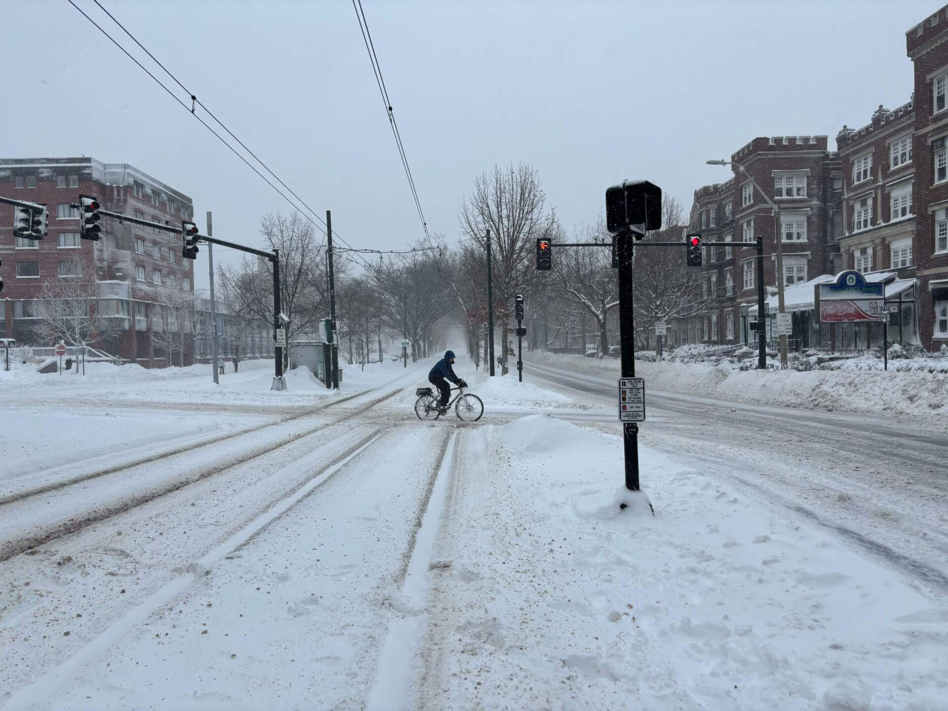 A long bicyclist crosses Beacon Street in Brookline on Monday. (Eve Zuckoff/WBUR)