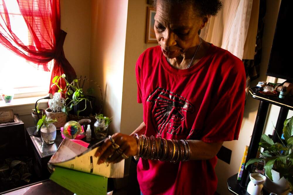 Thomas with the folder of information she keeps on her son's case.(Julia Goujiamanis for WBUR)