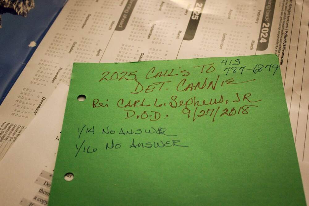 Thomas records each time she contacts the detective in her son's case. (Julia Goujiamanis for WBUR)