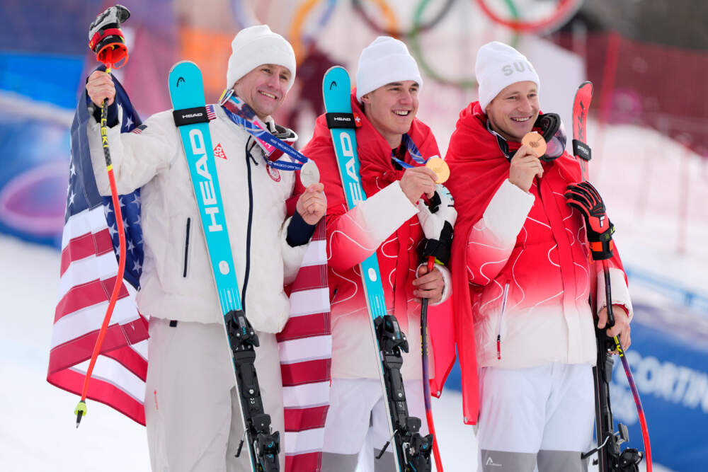 Switzerland's Franjo von Allmen, gold medalist in the men's super-G race, center, is flanked by silver medalist United States' Ryan Cochran-Siegle, left, and bronze medalist Switzerland's Marco Odermatt, Wednesday, Feb. 11, 2026.(Julia Demaree Nikhinson/AP)