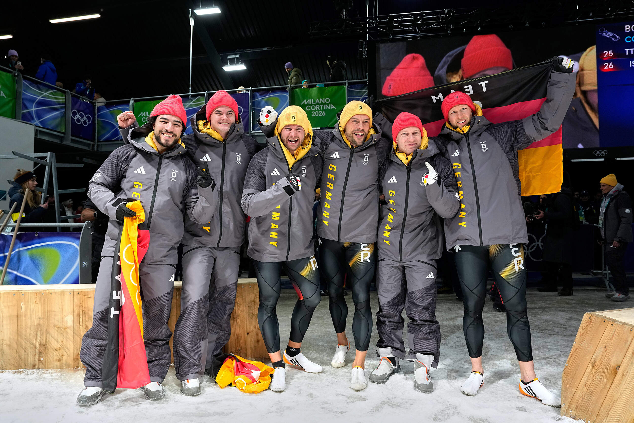 From left, Germany's bronze medalists Adam Ammour and Alexander Schaller, Germany's gold medalists Johannes Lochner and Georg Fleischhauer and Germany's silver medalists Francesco Friedrich and Alexander Schuller celebrate at the finish after the two man bobsled competition at the 2026 Winter Olympics, in Cortina d'Ampezzo, Italy, Tuesday, Feb. 17, 2026. (Alessandra Tarantino/AP)