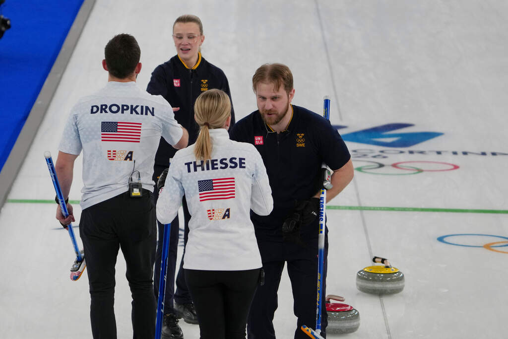 Sweden's Rasmus Wranaa and Isabella Wranaa shake hands with United States' Korey Dropkin and Cory Thiesse after winning the gold medal mixed doubles curling match against USA, at the 2026 Winter Olympics, in Cortina D'Ampezzo, Italy, Tuesday, Feb. 10, 2026. (Misper Apawu/AP)