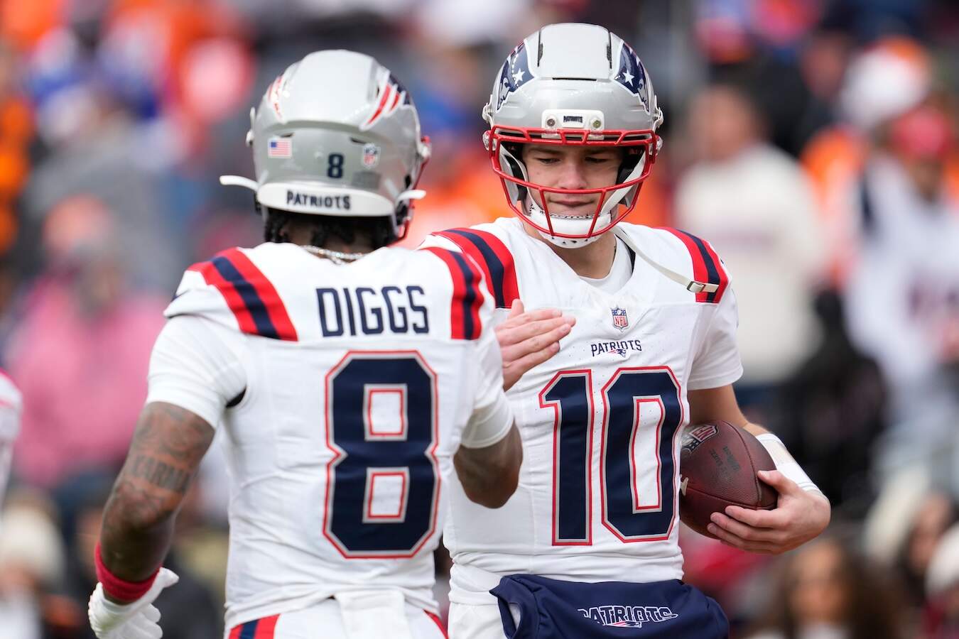 New England Patriots wide receiver Stefon Diggs (8) greets quarterback Drake Maye (10) before the AFC Championship game against the Denver Broncos last month. (Ashley Landis/AP)