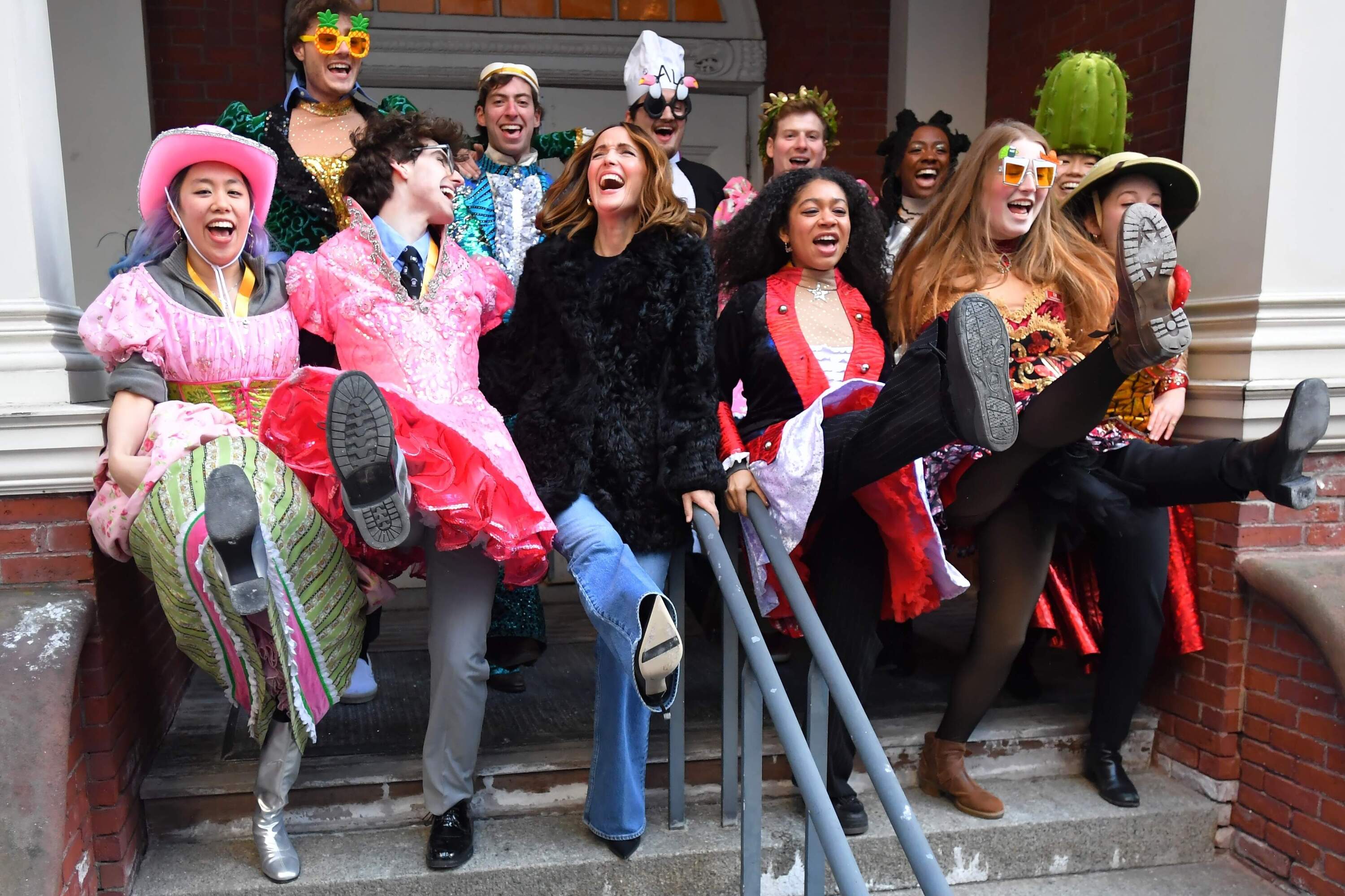 Rose Byrne, center, Hasty Pudding 2026 Woman of the Year, laughs while dancing with Harvard University theatrical students following a parade on Feb. 13 through Harvard Square, in Cambridge, Mass. (Steven Senne/AP)
