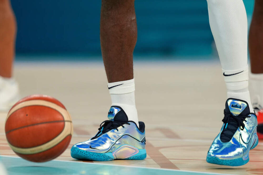 LeBron James wears shiny sneakers while warming up during a men's gold medal basketball game against France at Bercy Arena at the 2024 Summer Olympics, Saturday, Aug. 10, 2024, in Paris, France. (Rebecca Blackwell/AP File)