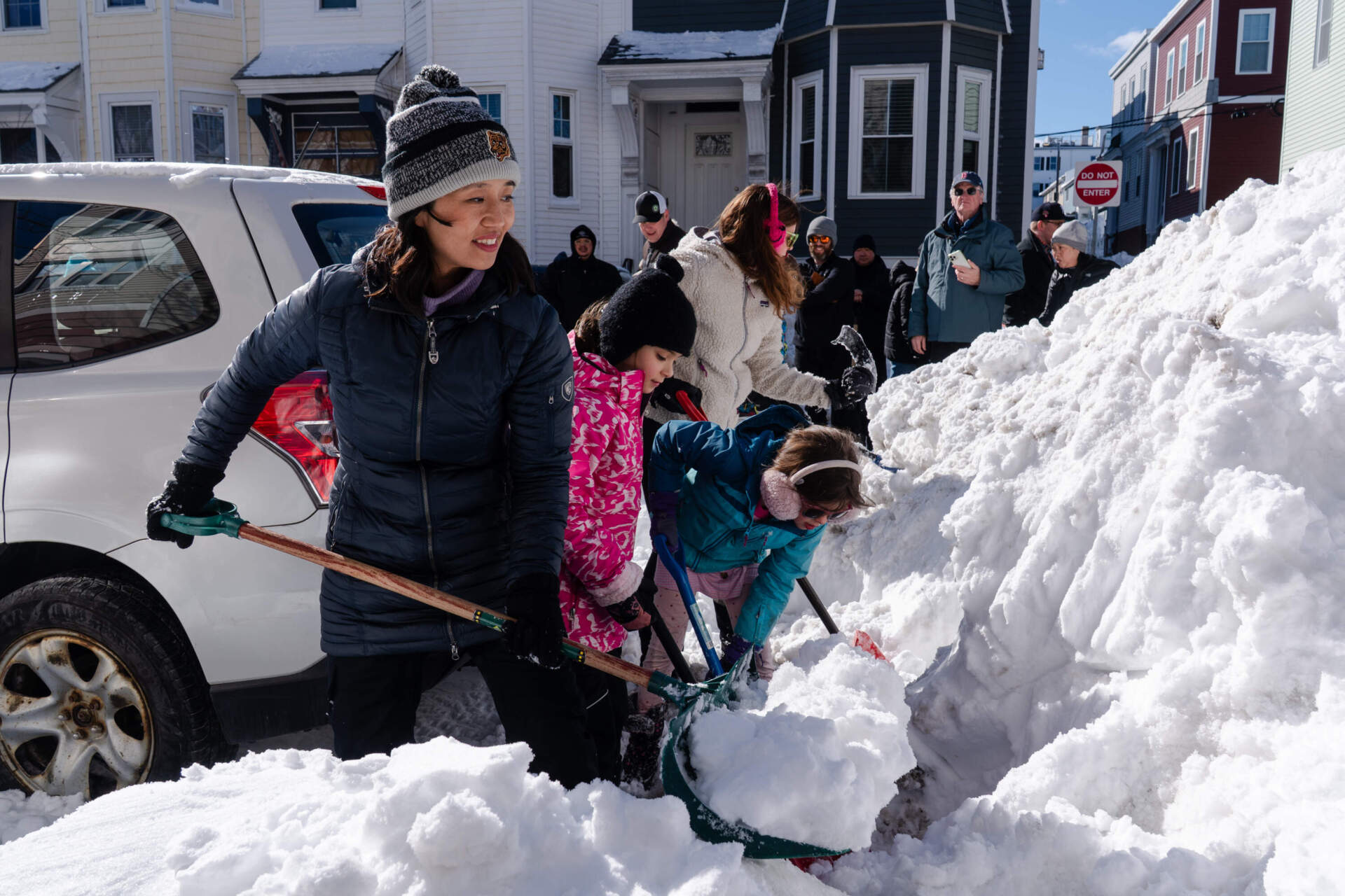Boston Mayor Michelle Wu, left, lends a hand shoveling snow from around a fire hydrant Tuesday in South Boston. (Sophie Park/AP)