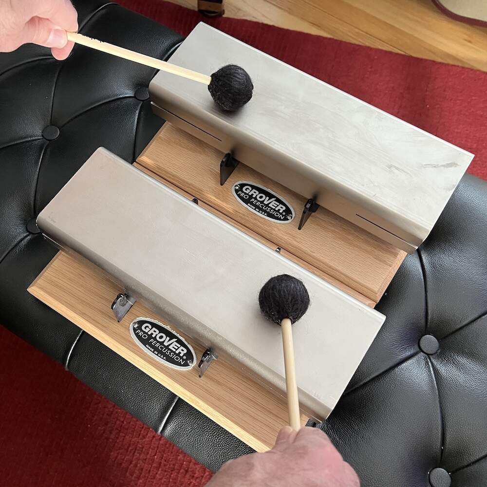 Eric Shimelonis plays the musical anvils. (image courtesy of Rebecca Sheir)