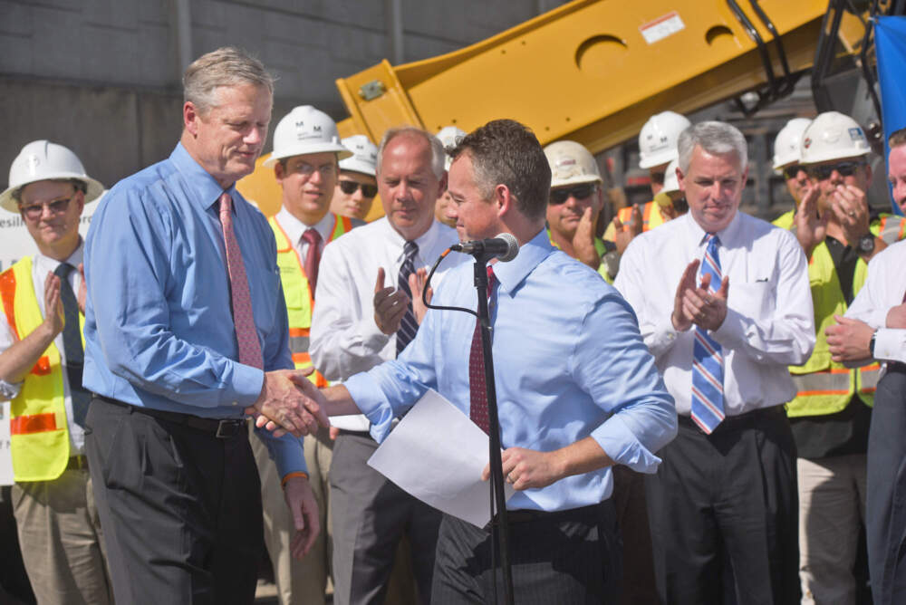 Then-Gov. Charlie Baker, left, is greeted by then-MBTA General Manager Brian Shortsleeve before talking with reporters at a press conference at the Caddigan MBTA Yard in Braintree, Mass., in 2016. (Patrick Whittemore/MediaNewsGroup/Boston Herald via Getty Images)
